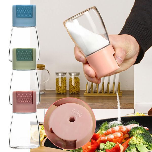 Glass salt shaker with push-button control for precise seasoning in the kitchen