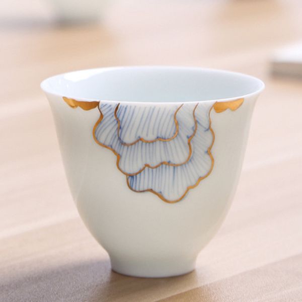 Hand-painted gold-trimmed ceramic teacup with matching saucer, a single cup for tea masters