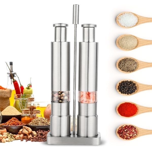 Manual salt and pepper grinder set with thumb push mechanism, stainless steel spice and sauce mills featuring a metal holder for kitchen use