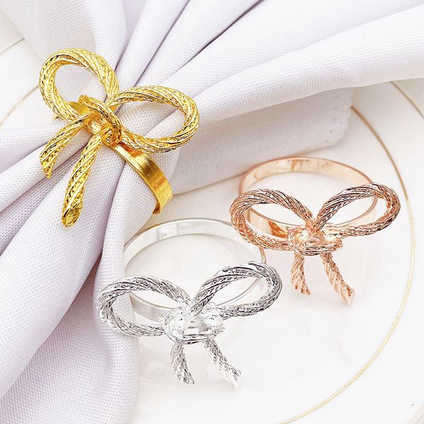 Metal bowtie napkin rings for elegant table decor at weddings, banquets, and family gatherings