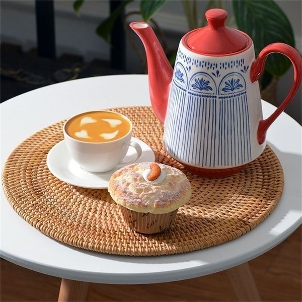 Natural woven rattan placemats for dining, featuring round and oval shapes with cutlery decoration