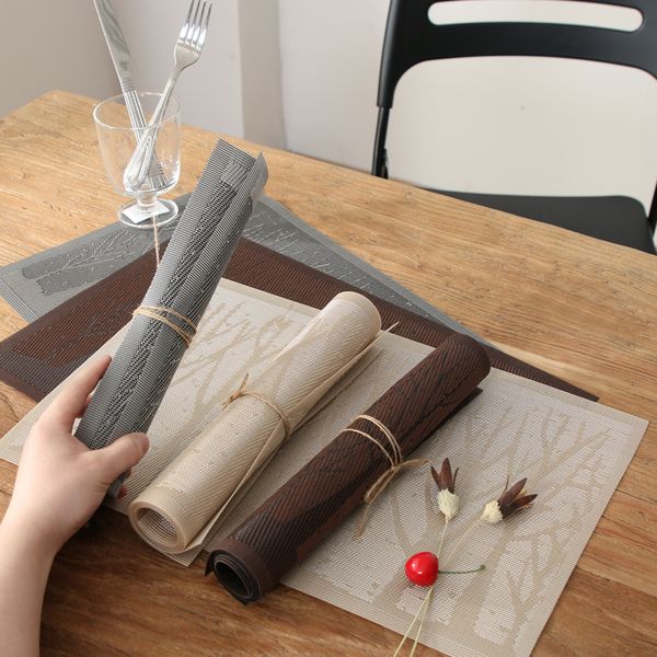 PVC dining placemats featuring tree designs, washable woven vinyl for heat insulation during meals