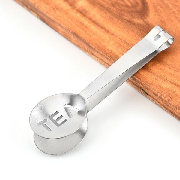 Reusable stainless steel tongs for tea bags, a squeezer, strainer, and holder with a metal spoon and mini sugar clip for tea leaves