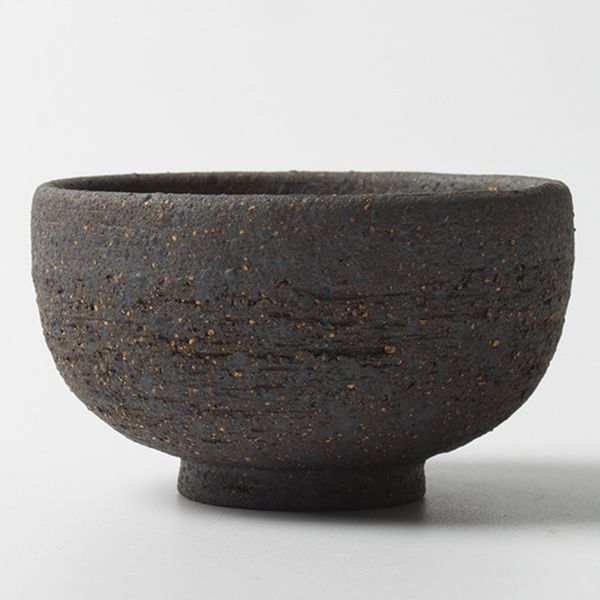 Vintage Japanese handmade coarse pottery teacup in black and purple sand ceramic, small and rough