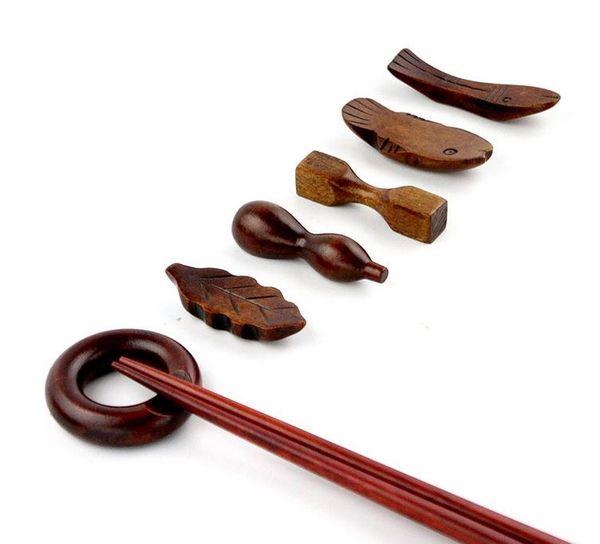 Wooden chopstick rest with various creative designs including large and small fish, gourd, dumbbell, round leaf shapes for holding chopsticks, model SN2923